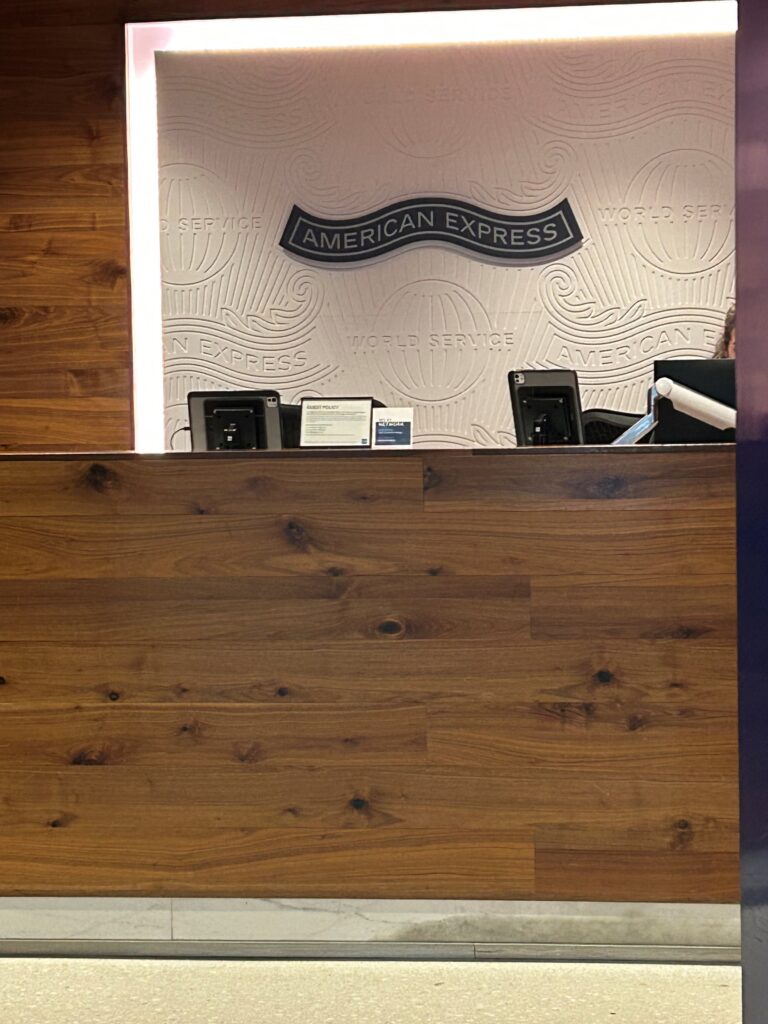 a desk with a sign on the wall