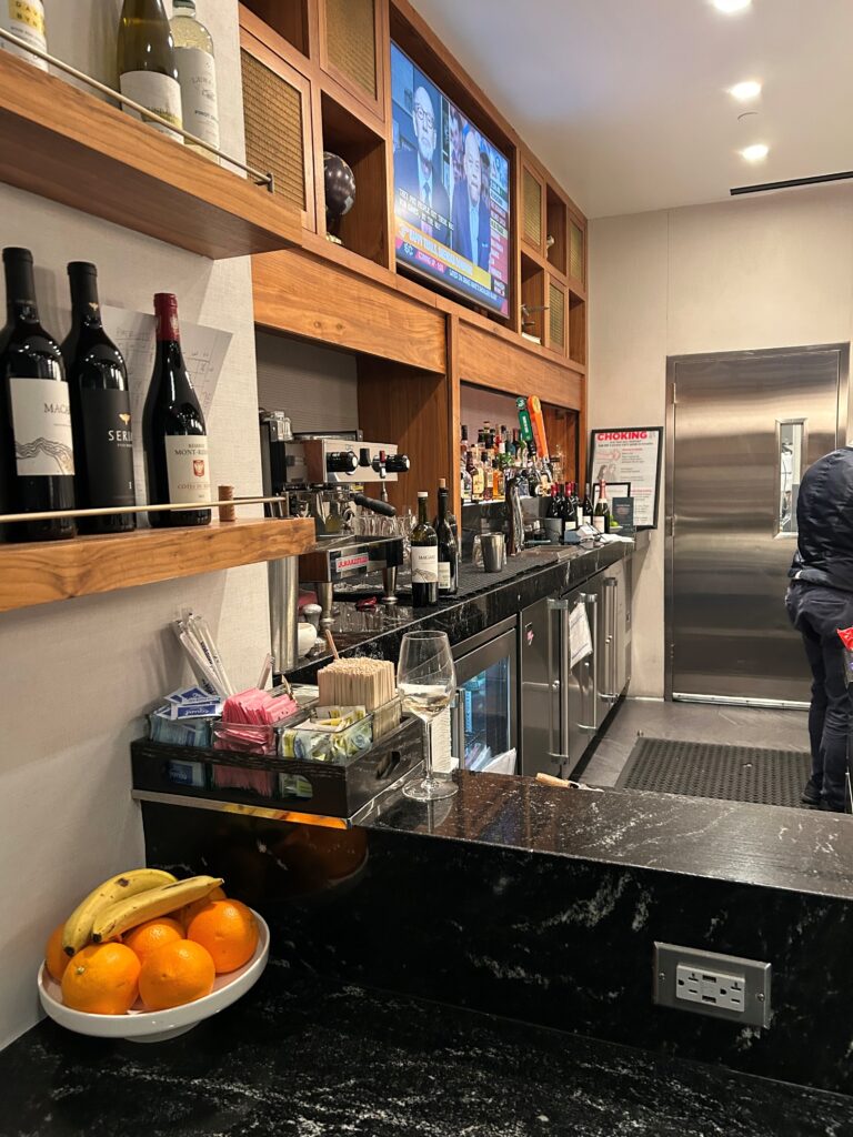 a bar with bottles of wine and oranges