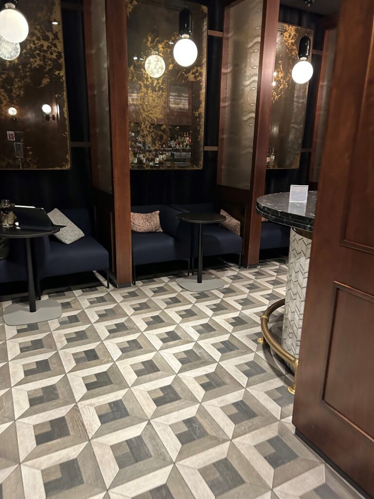 a room with a tile floor and a table and chairs