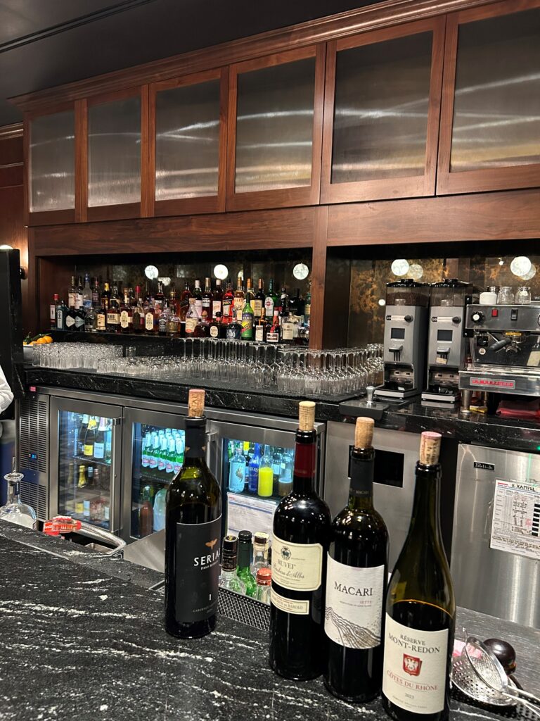 a bar with bottles of wine and glasses