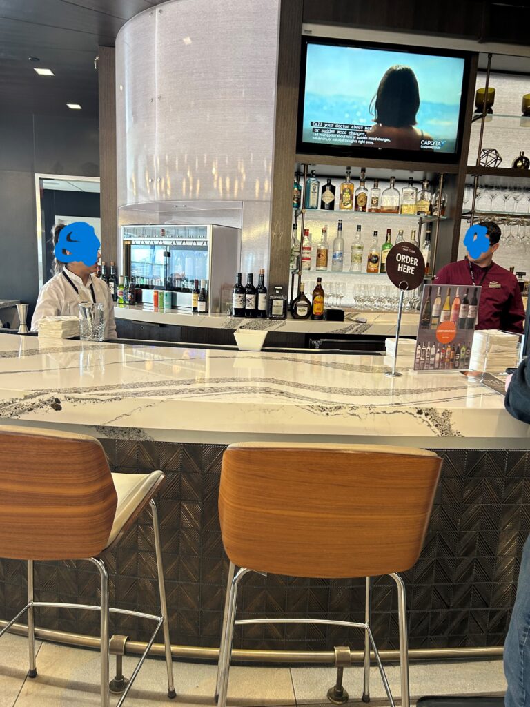 a bar with a counter and chairs