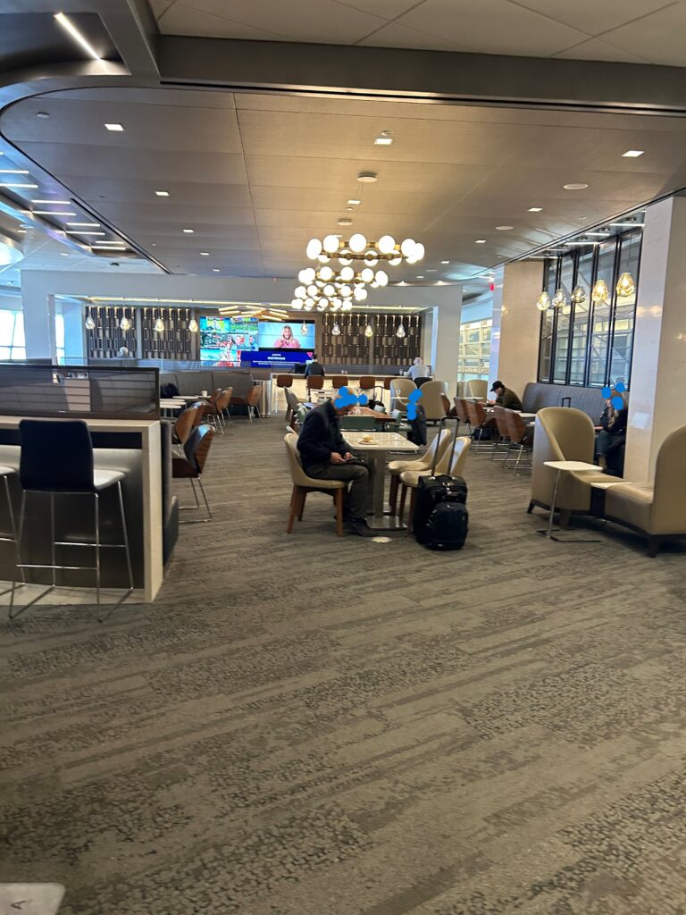 people sitting at tables in a room with chairs and tables