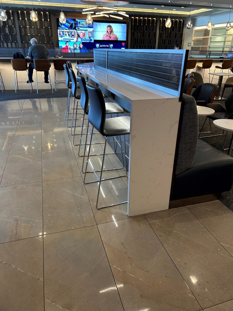 a bar with chairs and a tv