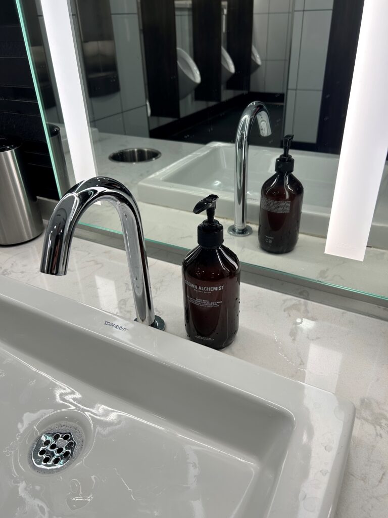 a bathroom sink with soap dispenser and faucet
