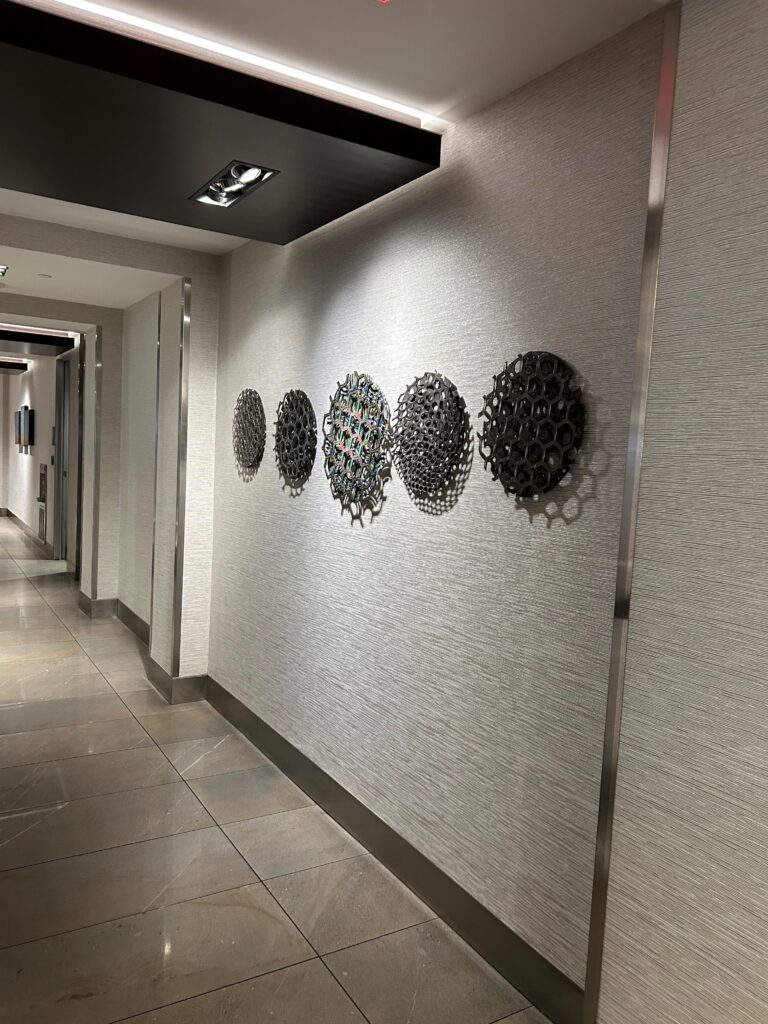 a hallway with a group of circular objects on the wall