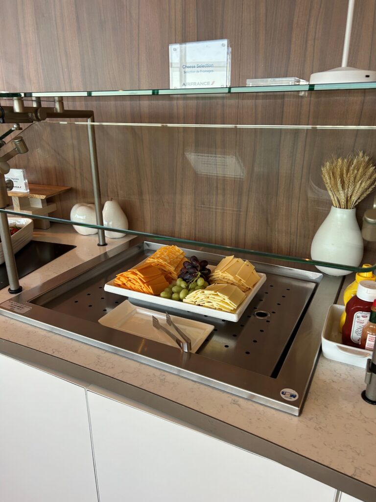 a tray of cheese and grapes on a counter