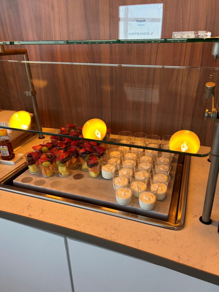 a tray of desserts and cups on a counter