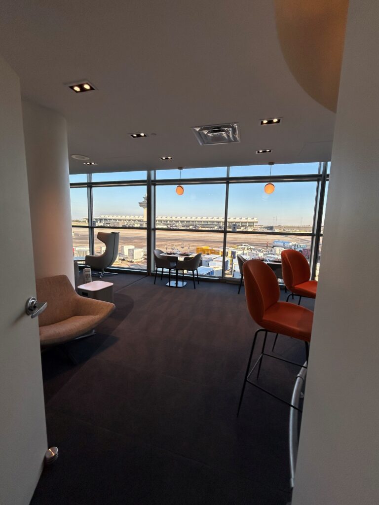 a room with chairs and a window