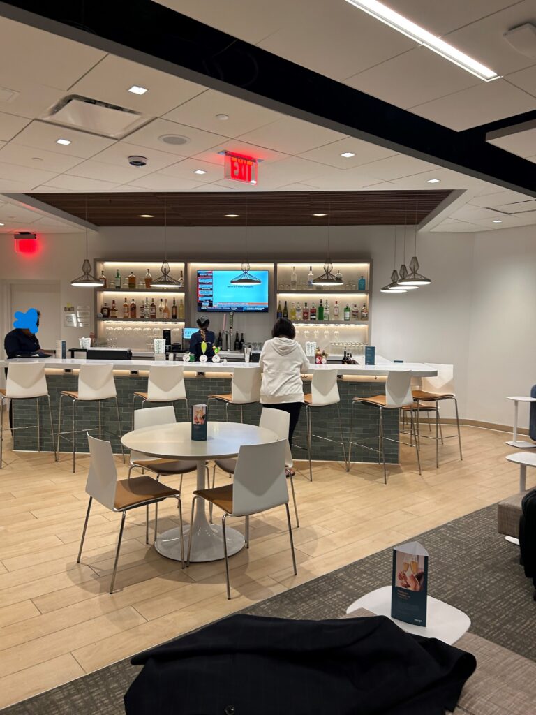 a group of people standing at a bar