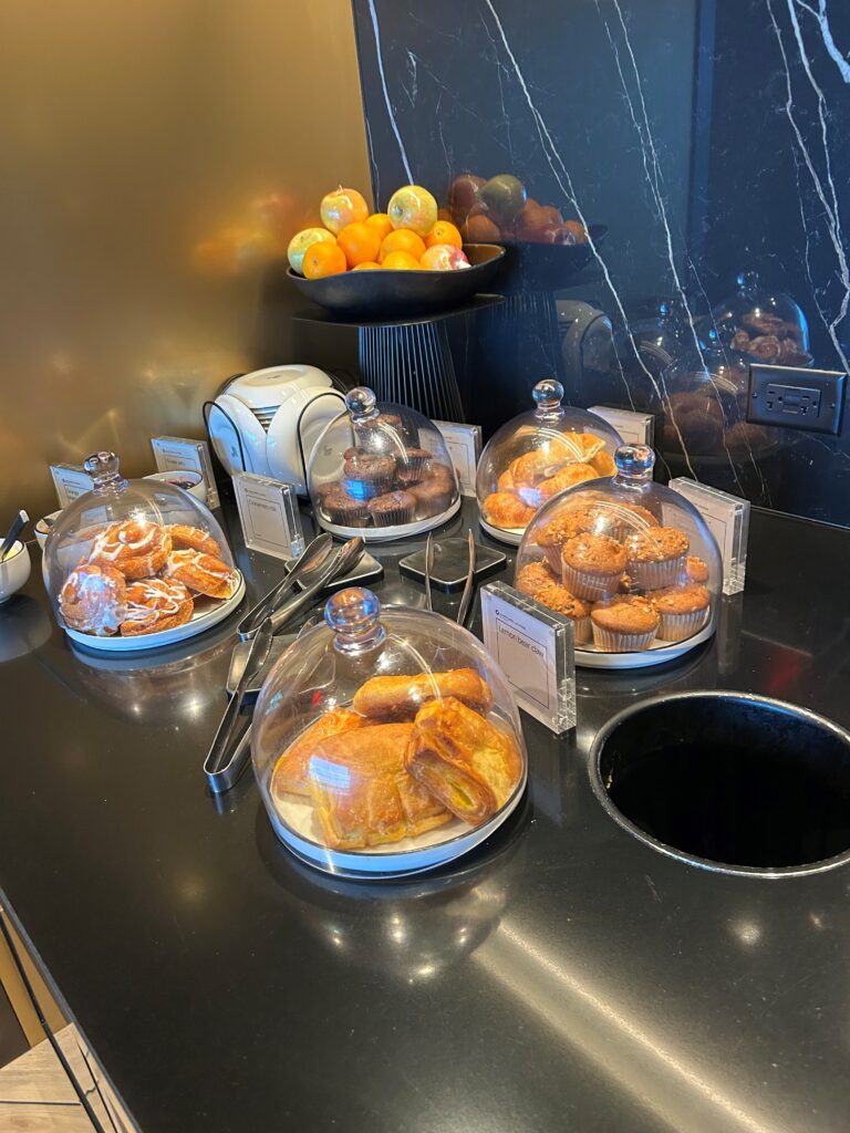 a display of pastries and oranges on a counter