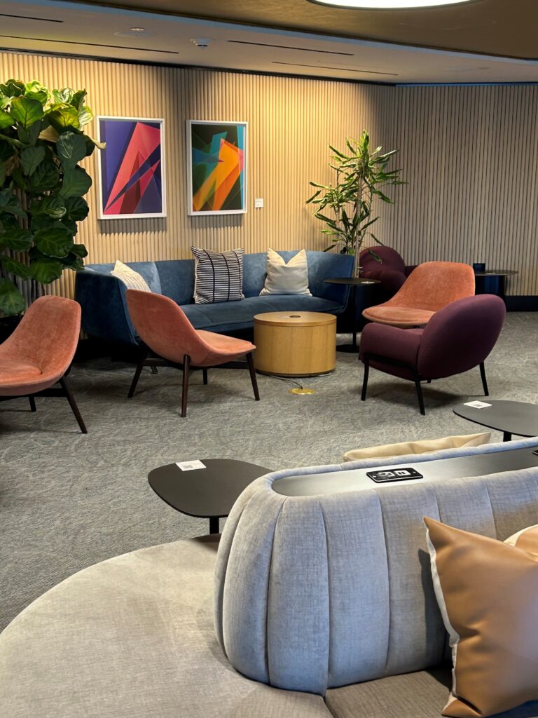 a room with a couch and chairs