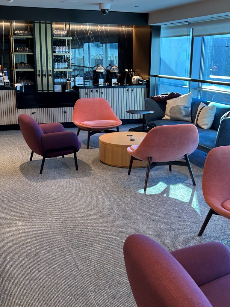 a room with a couch and chairs