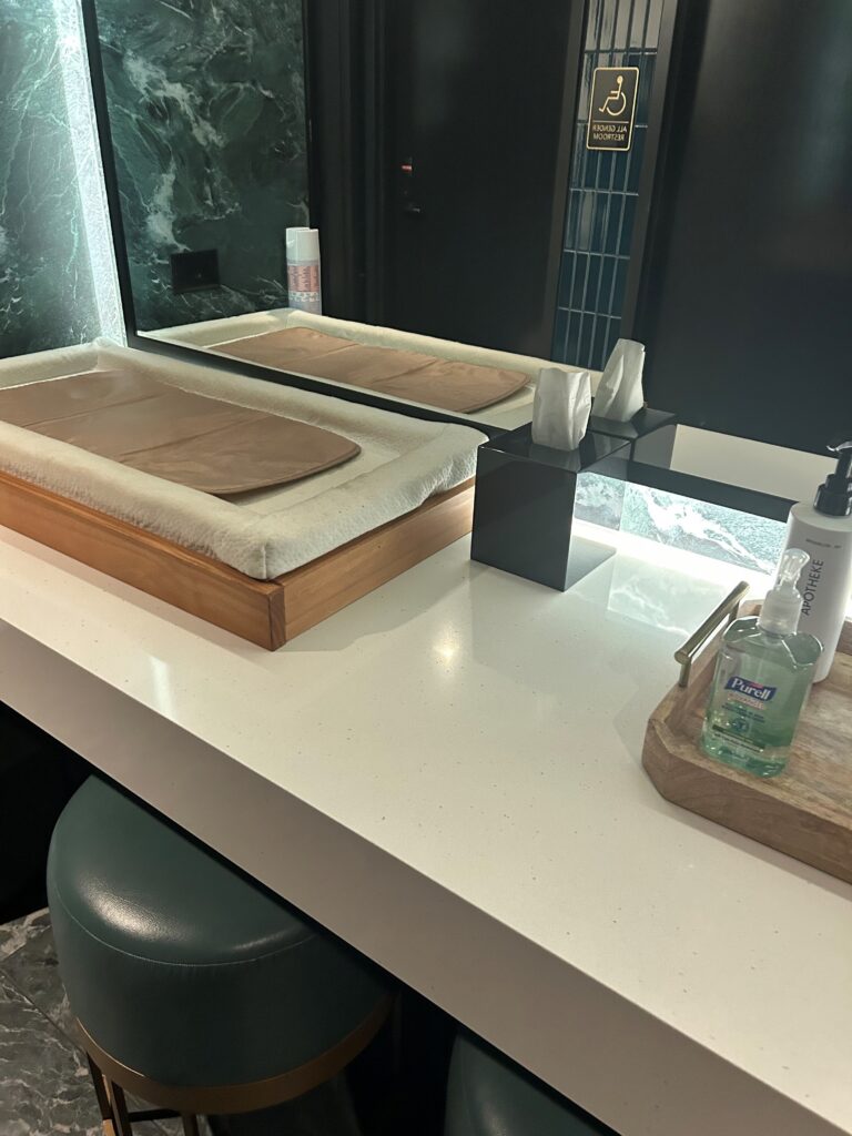 a bathroom counter with a mirror and a tray of soap