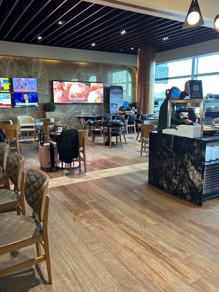 a room with chairs and tables and televisions